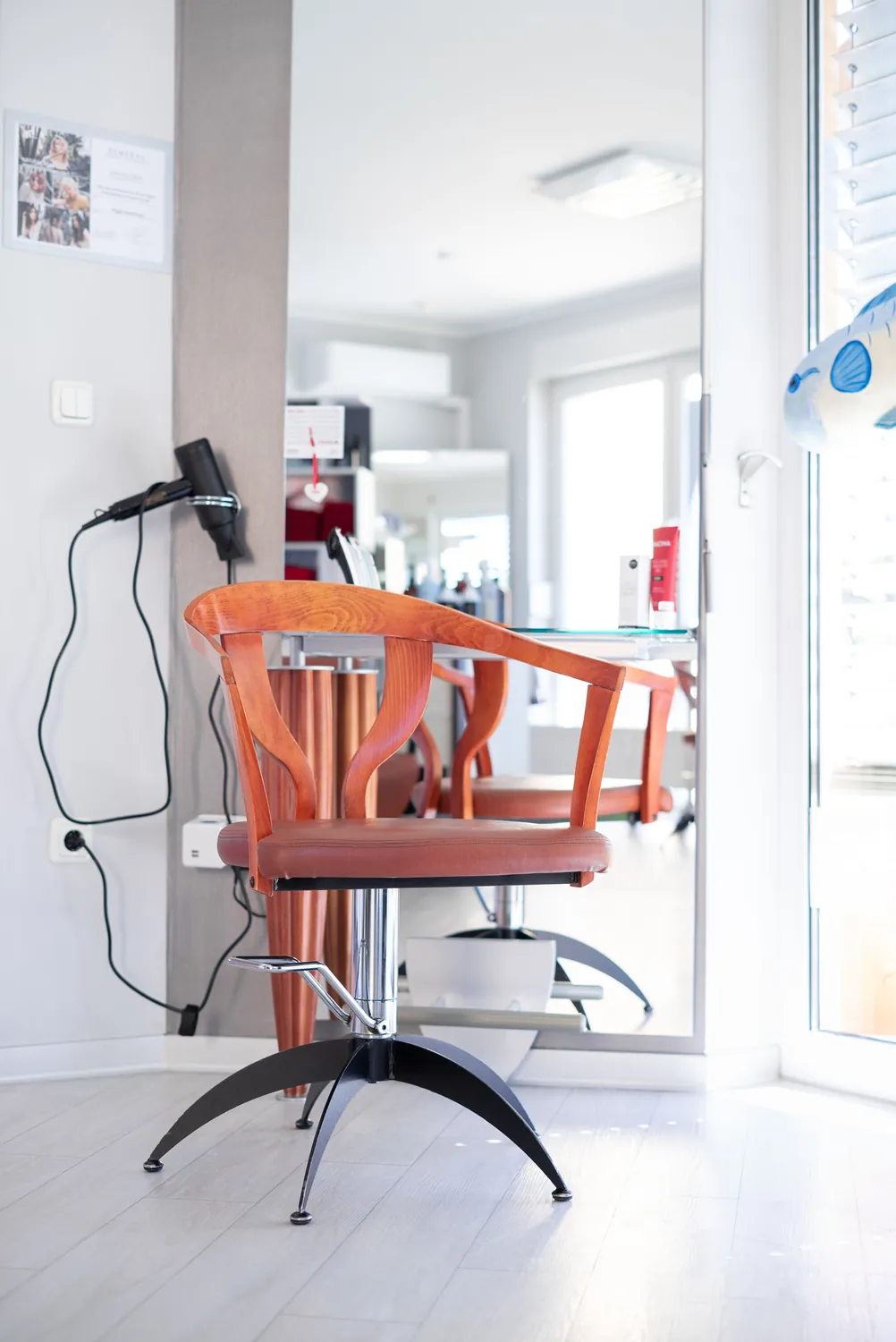 Heller Friseurplatz mit Fenster und Föhn im Salon P